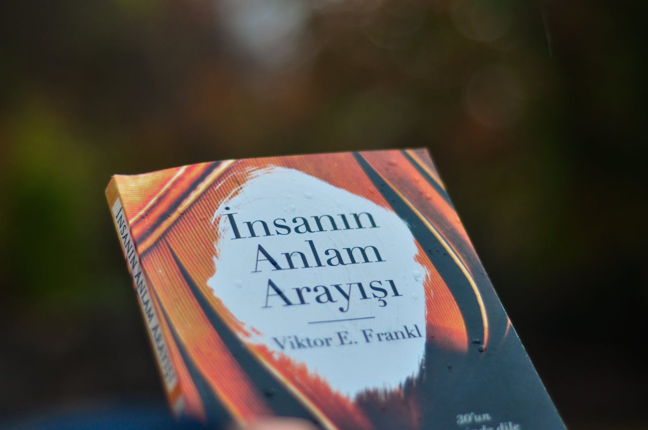 Close-up of 'Man's Search for Meaning' book cover by Viktor E. Frankl outdoors.